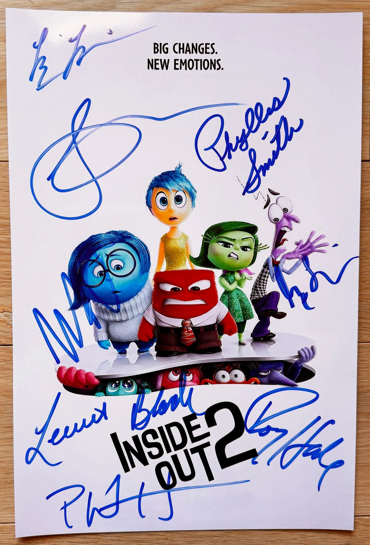An autographed poster of the movie Inside Out 2, signed photo by actors Amy Poehler, Phyllis Smith, Lewis Black, Tony Hale, Liza Lapria, Maya Hawke, Ayo Edebiri and Paul Walter Houser in blue ink signatures. autograph signed on 8x12 inch photograph photo Inside Out 2 autographs for sale.