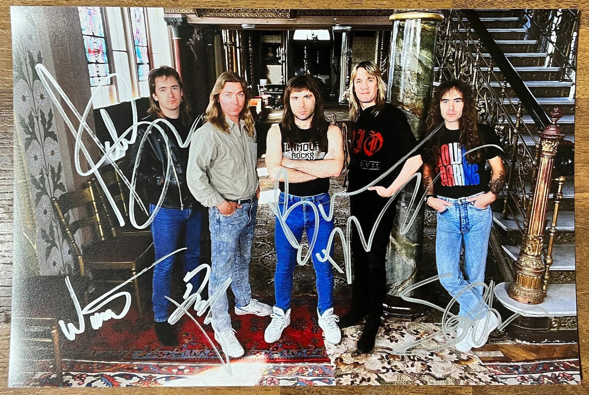 An autographed poster of the heavy metal band, Iron Maiden. Signed photo of Bruce Dickinson, Steve Harris, Adrian Smith, Dave Murray and Nicko McBrain in silver ink marker signatures. Photograph autographs for sale on 8x12 inch picture.
