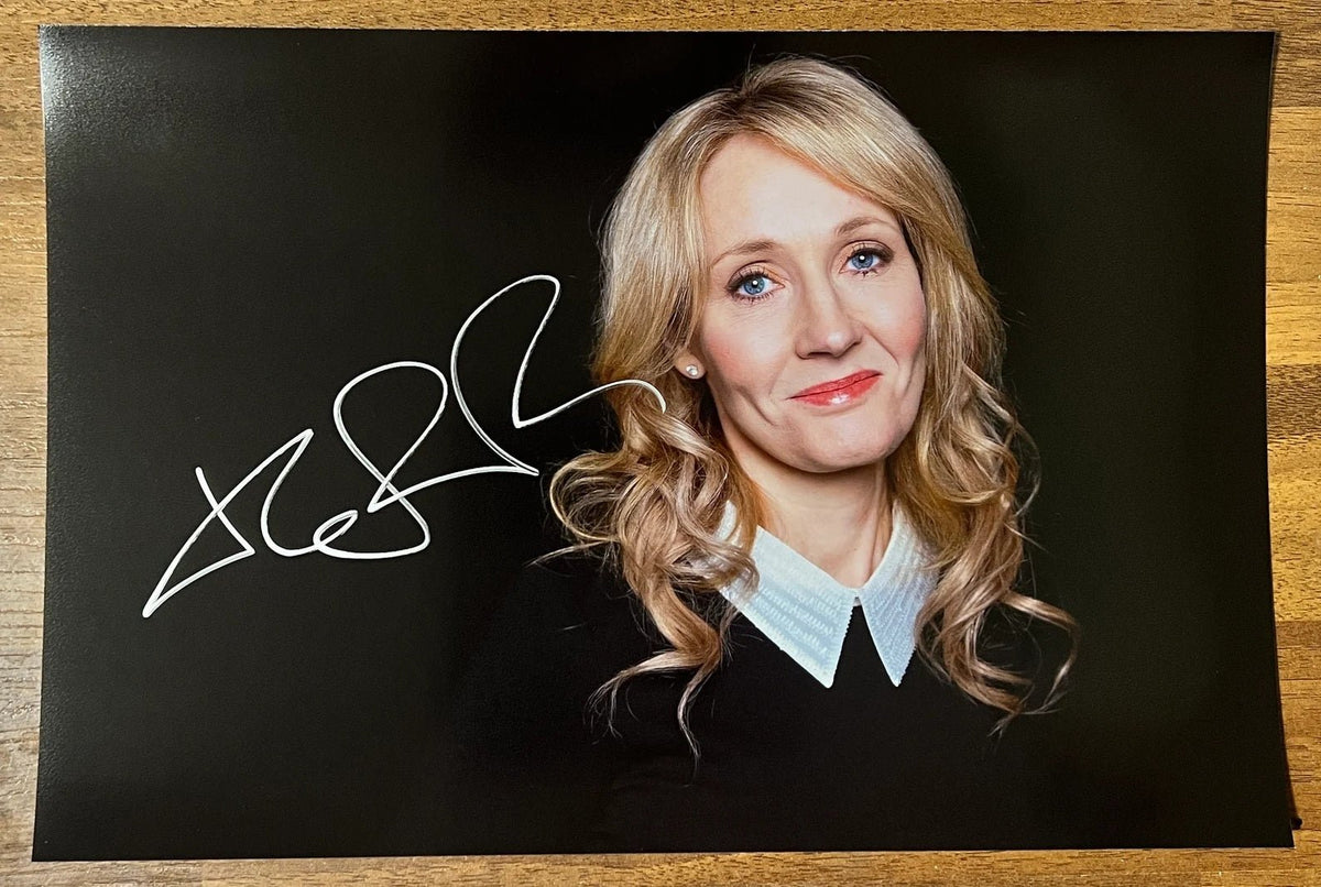 An autographed poster of Harry Potter author, J.K. Rowling. Signed photo in silver ink marker signature. Photograph autographs for sale on 8x12 inch picture.