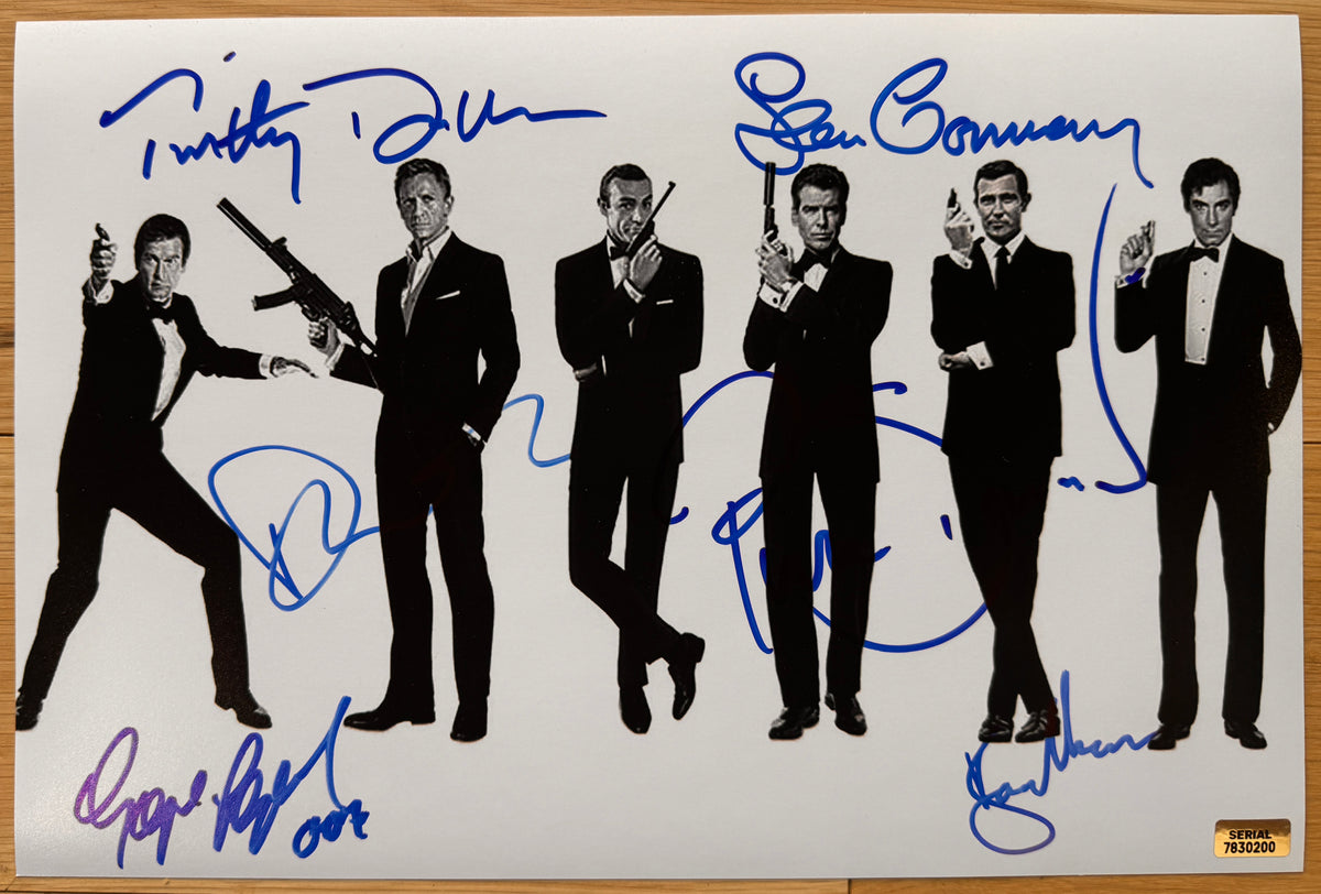 A cast autographed poster of all the actors who have played James Bond in the movies. Signed photo of Sean Connery, Pierce Brosnan, George Lazenby, Daniel Craig, Timothy Dalton and Roger Moore in blue ink marker signatures. Photograph autographs for sale on 8x12 inch picture.