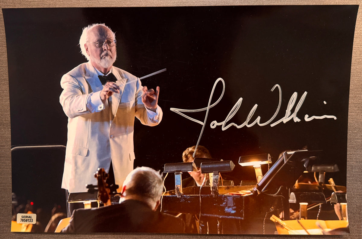 An autographed photo poster of star wars music composer, John Williams. Signed photo in silver ink marker signatures. Photograph John Williams autographs for sale on 8x12 inch picture.