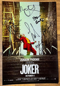 A cast autographed Joker movie poster. Signed photo of Joaquin Phoenix, Robert Deniro, Brett Cullen, Zazie Beetz, Marc Maron and Frances Conroy in black ink marker signatures. Photograph autographs for sale on 8x12 inch picture.