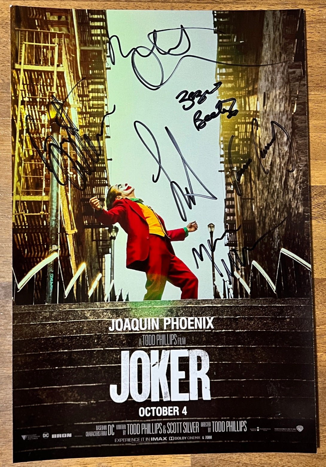 A cast autographed Joker movie poster. Signed photo of Joaquin Phoenix, Robert Deniro, Brett Cullen, Zazie Beetz, Marc Maron and Frances Conroy in black ink marker signatures. Photograph autographs for sale on 8x12 inch picture.