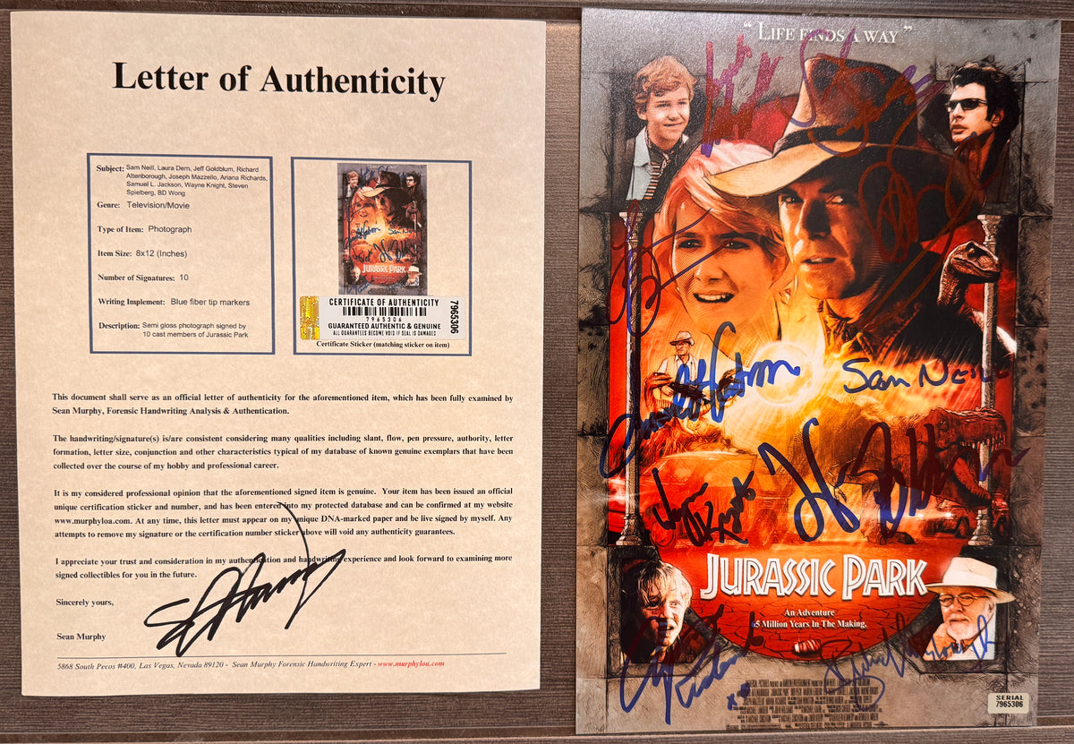 A cast autographed 8x12 Jurassic Park movie poster. Signed photo of Sam Neill, Laura Dern, Jeff Goldblum, Richard Attenborough, Joseph Mazzello, Ariana Richards, Samuel L. Jackson, Wayne Knight, Steven Spielberg and BD Wong in blue ink marker signatures. Photograph autographs for sale on 8x12 inch picture with COA.