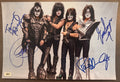 A complete autographed photo poster of the rock n roll band, KISS. Signed photo of Gene Simmons, Paul Stanley, Eric Singer and Tommy Thayer in blue ink marker signatures. Photograph KISS autographs for sale on 8x12 inch picture.