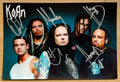 A band autographed poster of the band Korn. Signed photo of Jonathan Davis, Munky, Head, Fieldy and David Silveria in silver ink marker signatures. Photograph autographs for sale on 8x12 inch picture.