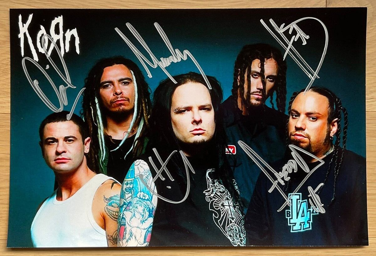A band autographed poster of the band Korn. Signed photo of Jonathan Davis, Munky, Head, Fieldy and David Silveria in silver ink marker signatures. Photograph autographs for sale on 8x12 inch picture.
