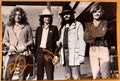 A signed poster of the rock band, Led Zeppelin. Signed photo of Robert Plant, Jimmy Page and John Paul Jones in gold ink marker signatures. Photograph autographs for sale on 8x12 inch picture.