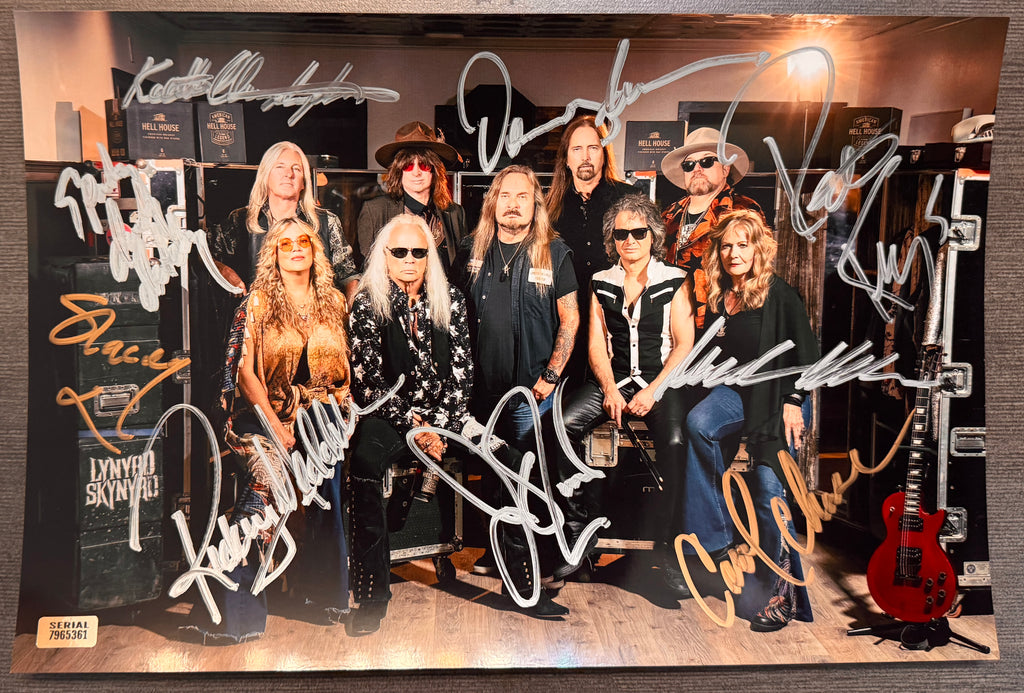 An autographed photo poster of the band,  Lynyrd Skynyrd. signed photo of Johnny Van Zant, Rickey Medlocke, Michael Cartellone, Mark Matejka, Peter Keys, Damon Johnson, Keith Christopher, Carol Chase and Stacey Michelle in silver and gold ink marker signatures. photograph lynyrd skynyrd autographs for sale on 8x12 inch picture.