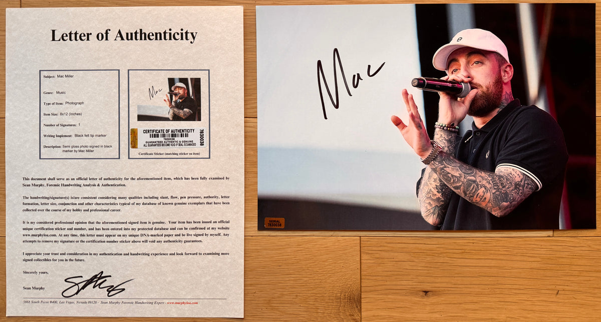 An autographed photo print of musician Mac Miller, signed photograph in black marker on the left side. The photo shows Mac Miller performing on stage wearing a white baseball cap and a black polo shirt, holding a microphone. poster and autographs for sale with COA.