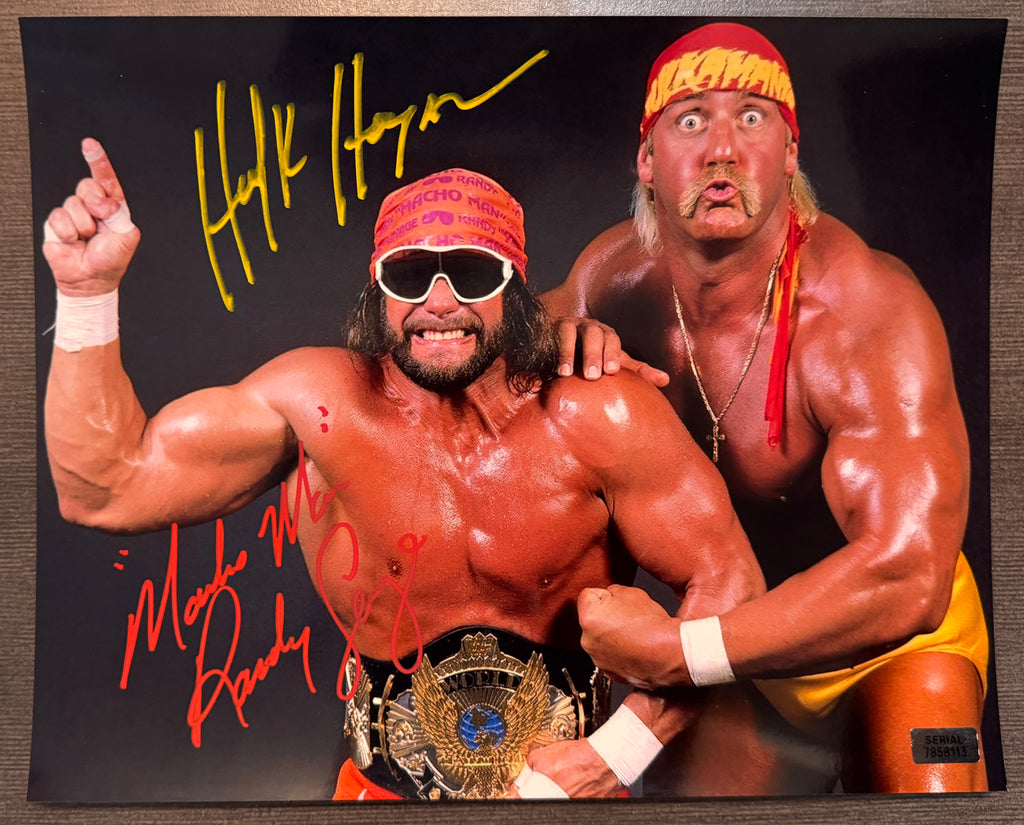 An autographed 8x10 photograph of professional wrestlers Hulk Hogan and Randy Savage posing together against a black background, featuring their signatures in yellow and red marker. Signed autographs auto on 8x12 inch picture. Photograph autographs for sale.