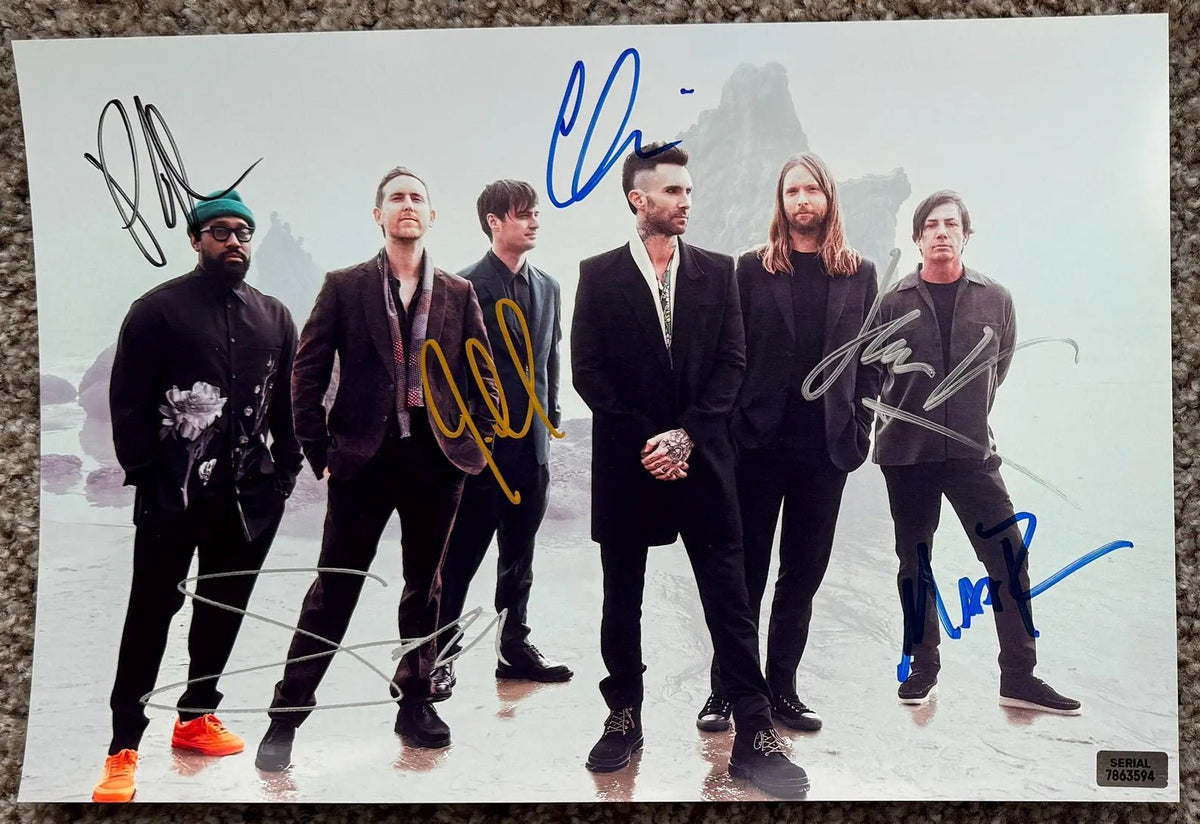 An autographed photo poster of the band Maroon 5. Signed poster by Adam Levine, Jesse Carmichael, James Valentine, Matt Flynn, PJ Morton and Sam Farrar in blue black gold and silver marker ink signatures. photograph Maroon 5 autographs for sale on 8x12 inch picture.