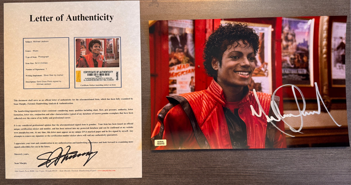 An autographed 8x12 photograph of Michael Jackson in the red jacket, signed in silver marker with COA.