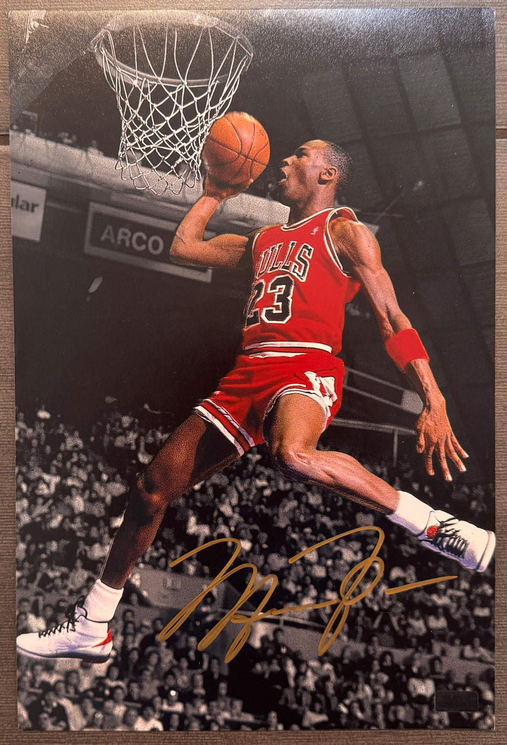 An autographed nba Chicago Bulls upper deck auto photo poster of Michael Jordan. Signed photograph in gold ink marker signatures. Photograph Michael Jordan autographs for sale on 8x12 inch picture.