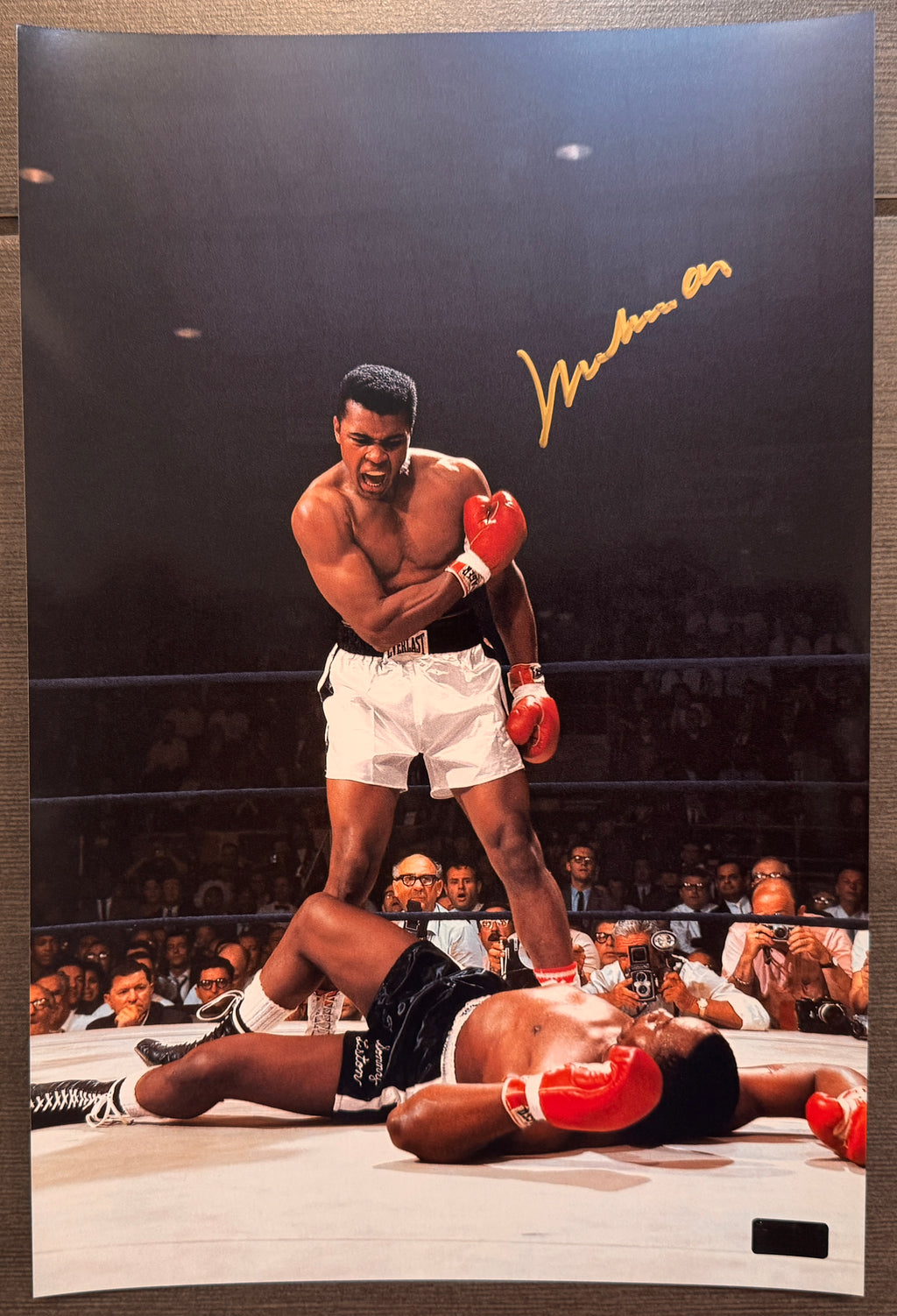 An autographed upper deck master collection auto photo poster of boxer, Muhammad Ali. Also known as Cassius Clay. Signed photograph in gold ink marker signatures. Photograph Muhammad Ali autographs for sale on 8x12 inch picture.