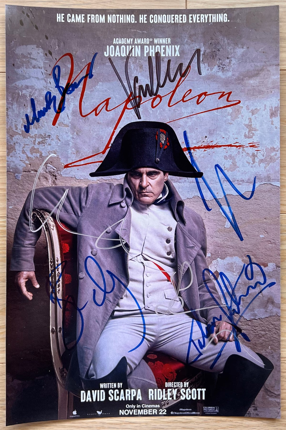 A cast signed autographed photo poster from the movie, Napolean. Signed photo of Joaquin Phoenix, Vanessa Kirby, Ben Miles, Ludivine Sagnier, Mark Bonnar and Tahar Rahim in silver black and blue ink markers signatures. photograph Napolean autographs for sale on 8x12 inch picture.