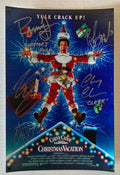 A cast autographed poster of the christmas movie, National Lampoons Christmas Vacation.  Signed photo of Chevy Chase, Beverly D'Angelo, Randy Quaid, Juliette Lewis and Johnny Galecki in silver ink signatures. Photograph autographs for sale on 8x12 inch picture.