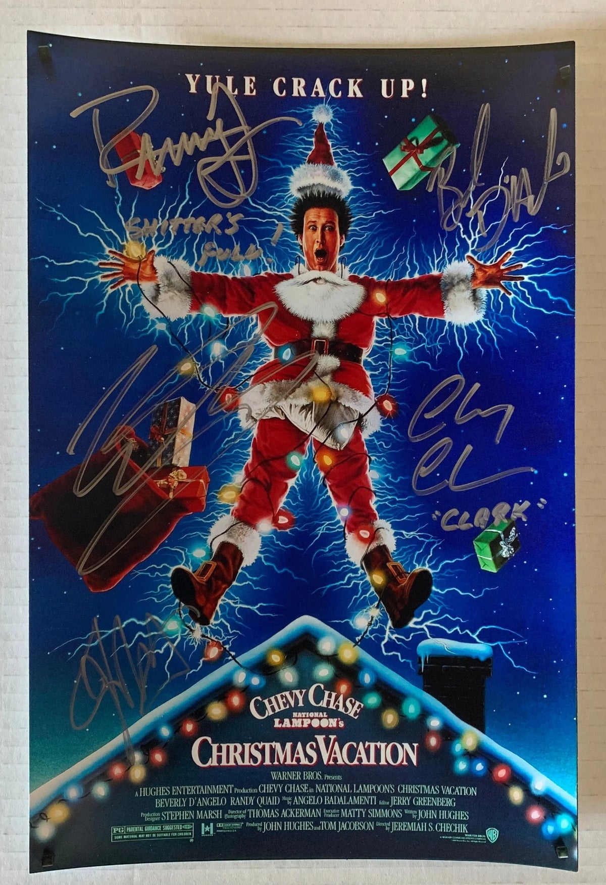 A cast autographed poster of the christmas movie, National Lampoons Christmas Vacation.  Signed photo of Chevy Chase, Beverly D'Angelo, Randy Quaid, Juliette Lewis and Johnny Galecki in silver ink signatures. Photograph autographs for sale on 8x12 inch picture.