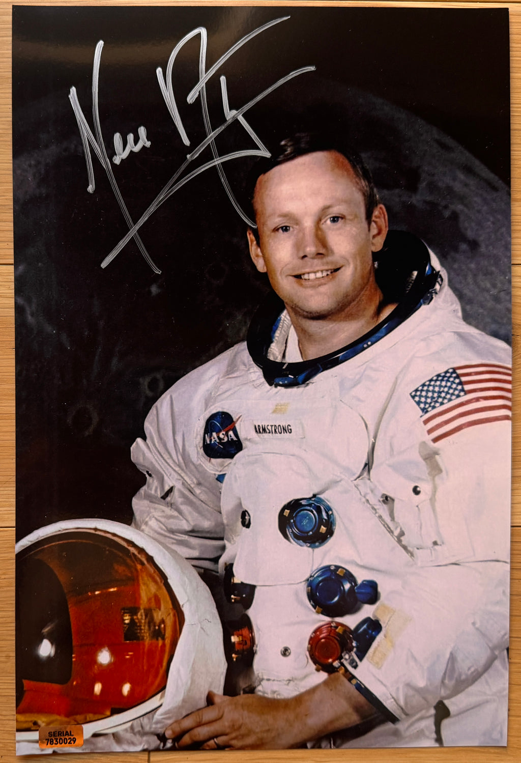 An autographed poster of NASA astronaut, Neil Armstrong. Signed photo of his Apollo 11 mission in silver ink marker signatures. Photograph autographs for sale on 8x12 inch picture.