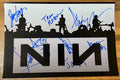 A band signed poster of the band Nine Inch Nails. Signed photo of Trent Reznor, Jeordie White, Josh Freese, Alessandro Cortini, Aaron North, Mark Ellis, Danny Lohner and Andy Kubiszewski in blue in marker signatures. Photograph autographs for sale on 8x12 inch picture.