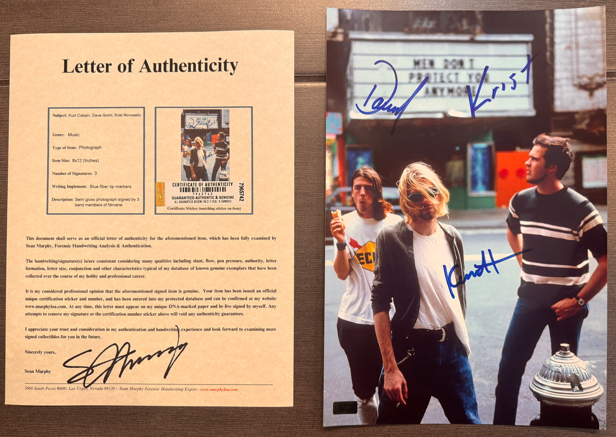 An autographed photo poster of the 90's band, Nirvana. Signed photo of Kurt Cobain Dave Grohl and Krist Novoselic in blue ink marker signatures. Photograph Kurt Cobain autographs for sale on an 8x12 inch picture with COA.