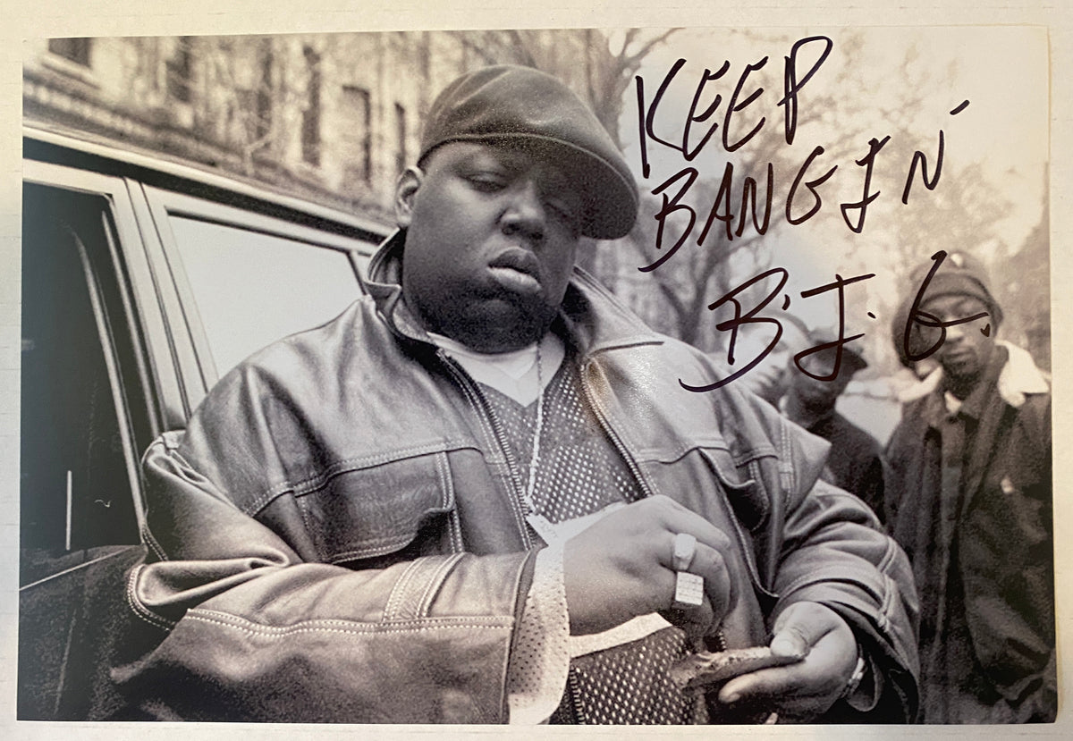 An autographed photo poster of the hip hop rapper, Notorious B.I.G. also spelled as BIG. Signed photo and inscribed in black ink marker signatures. Photograph Notorious B.I.G. autographs for sale on 8x12 inch picture.