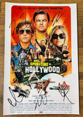 A cast autographed photo poster from the movie, Once Upon a Time in Hollywood. Signed photo of Brad Pitt, Leonardo DiCaprio, Margot Robbie, Emile Hirsch and Quentin Tarantino in black ink marker signatures. Photograph Once Upon a Time in Hollywood autographs for sale on picture.