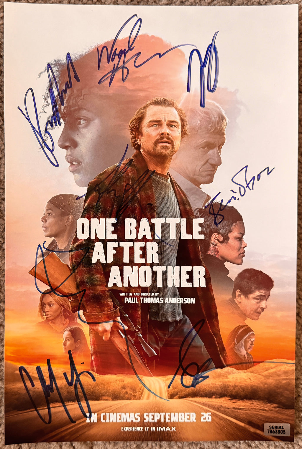 A cast autographed poster of the movie One Battle After Another. Signed photo of Leonardo DiCaprio, Sean Penn, Benicio Del Toro, Regina Hall, Teyana Taylor, Alana Haim, Wood Harris and Chase Infinit in blue ink marker signatures. Photograph autographs for sale on 8x12 inch picture.