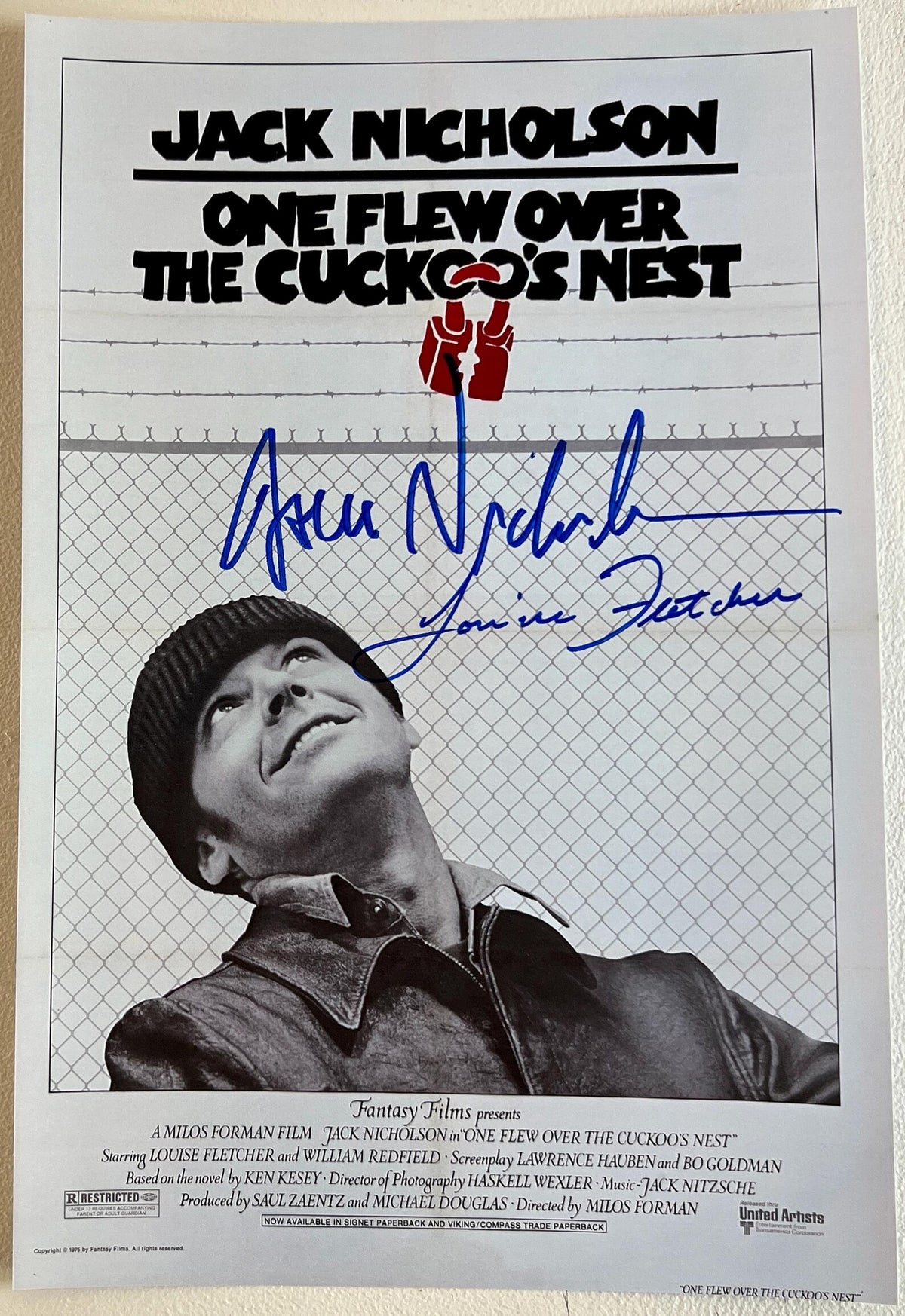 A cast autographed photo poster from the movie, One Flew Over the Cuckoo's Nest. Signed photo of Jack Nicholson and Louise Fletcher in blue ink marker siagntures. Photograph Jack Nicholson autographs for sale on 8x12 inch picture.