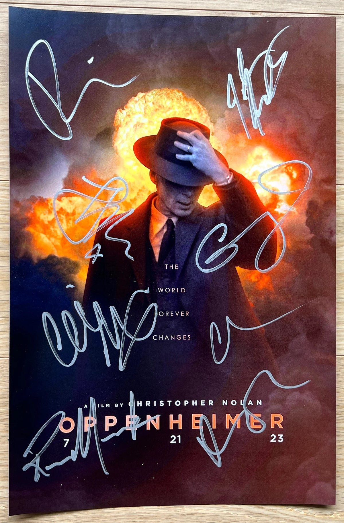 A cast autographed photo poster from the movie, Oppenheimer. Signed photo of Cillian Murphy, Emily Blunt, Matt Damon, Robert Downey Jr, Florence Pugh, Josh Hartnett, Casey Affleck and Rami Malek in silver ink marker signatures. Photograph autographs for sale on 8x12 inch picture.