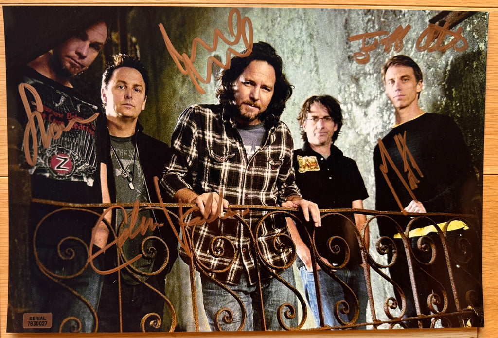 An autographed poster of rock band, Pearl Jam. Signed photo of Eddie Vedder, Mike McCready, Stone Gossard, Jeff Ament and Matt Cameron in gold ink marker signatures. Photograph autographs for sale on 8x12 inch picture.