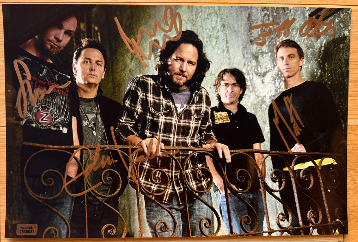 An autographed poster of rock band, Pearl Jam. Signed photo of Eddie Vedder, Mike McCready, Stone Gossard, Jeff Ament and Matt Cameron in gold ink marker signatures. Photograph autographs for sale on 8x12 inch picture.
