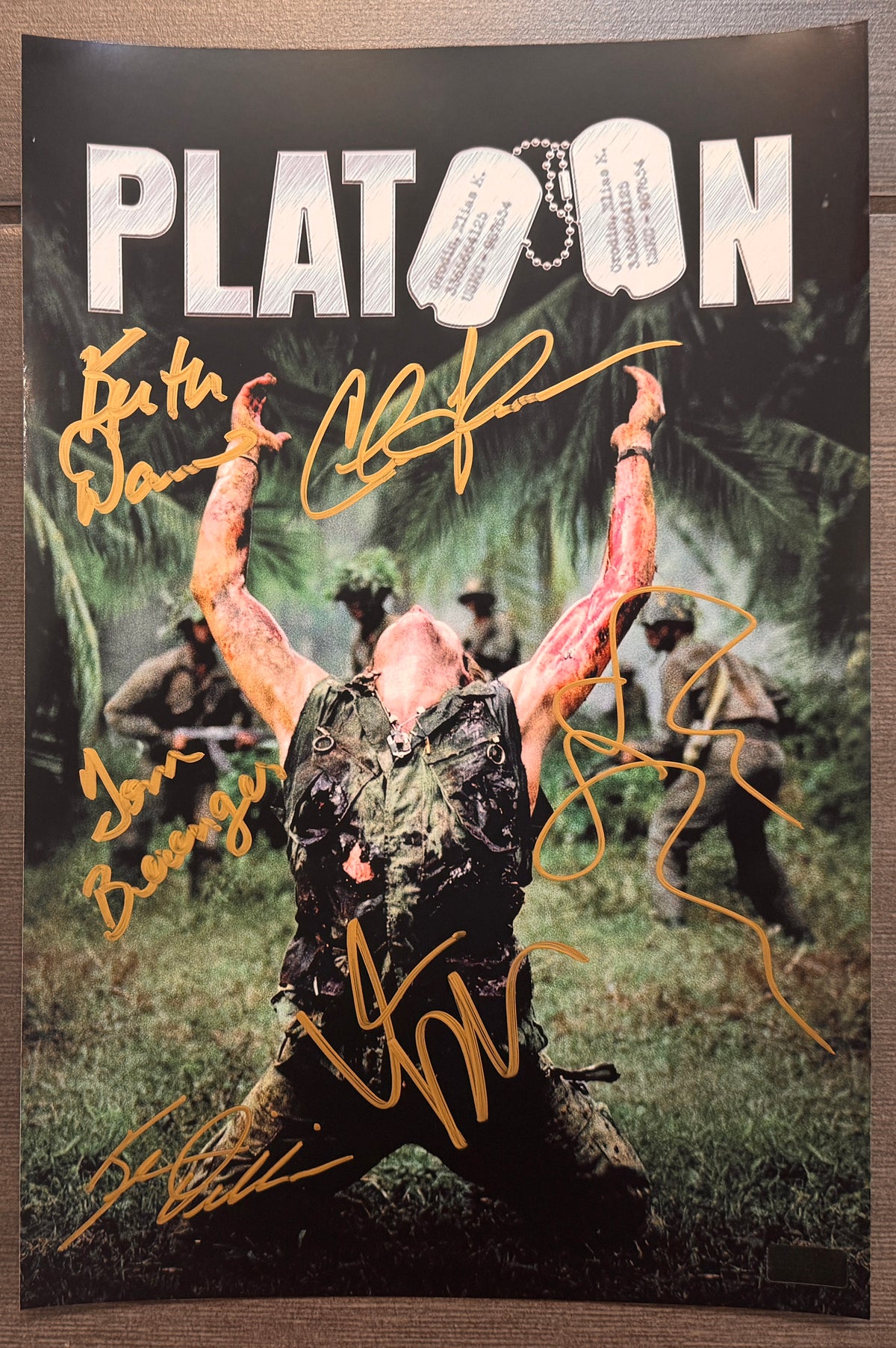 A cast autographed photo poster of the 1986 movie, Platoon. Signed photograph of Charlie Sheen, Tom Berenger, Willem Dafoe, Kevin Dillon, Keith David and Oliver Stone in gold ink marker signatures. Photograph Platoon autographs for sale on 8x12 inch picture.