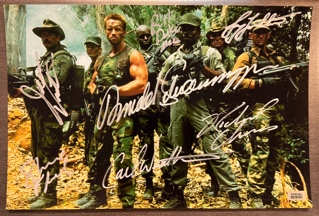 A cast autographed poster of the movie, Predator. Signed photo of Arnold Schwarzenegger, Carl Weathers, Bill Duke, Sonny Landham, Jesse Ventura, Richard Chaves and Shane Black in silver ink marker signatures. Photograph autographs for sale on 8x12 inch picture.