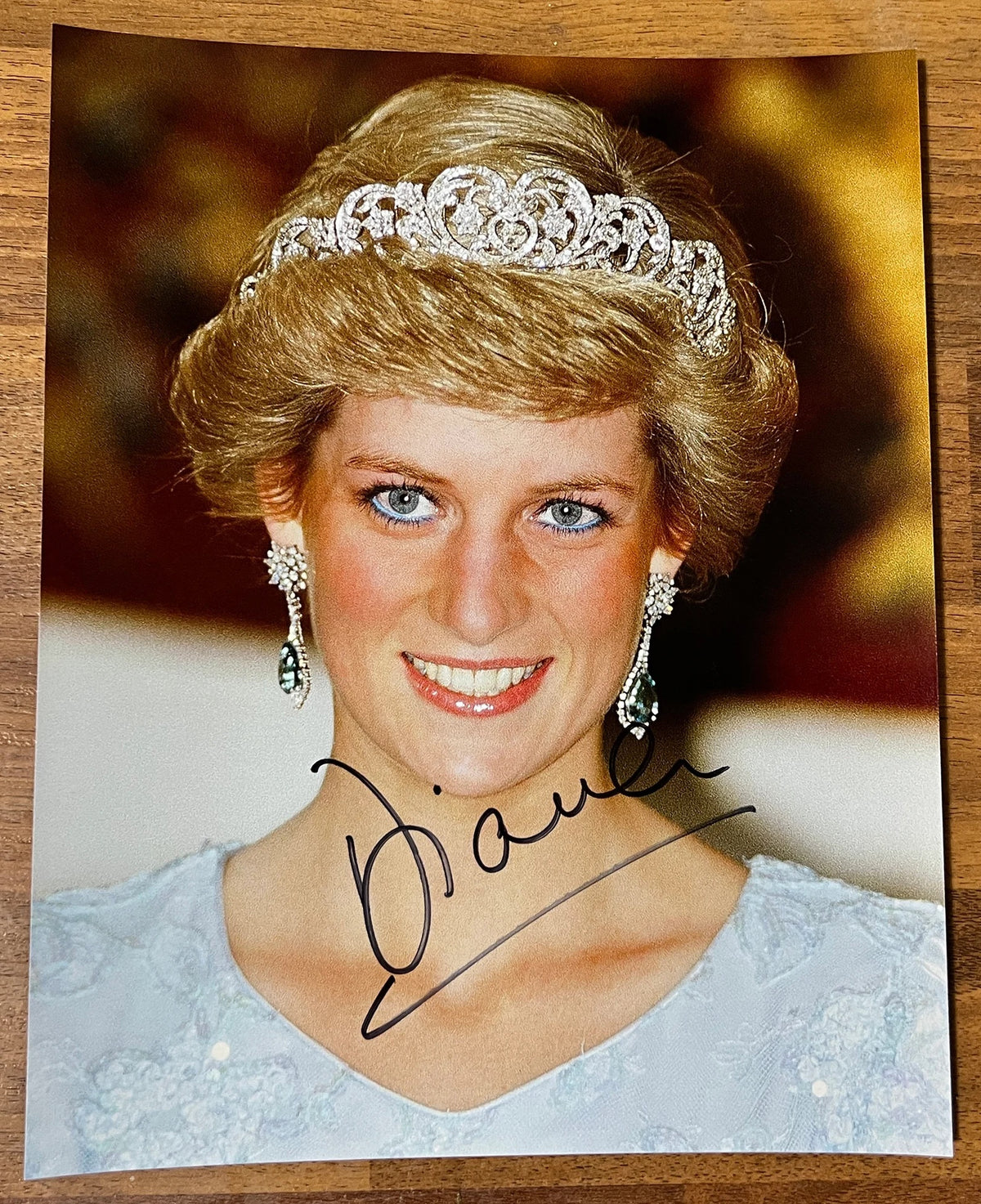 An autographed photo print of Princess Diana wearing a silver tiara and earrings, signed in black ink across the lower portion. signed in black ink autograph. photograph poster is 8x10 inches Princess Diana autographs for sale.