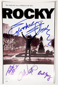 A cast autographed photo poster from the 1976 movie, ROCKY. Signed photo of Sylvester Stallone, Talia Shire, Carl Weathers, Burt Young in blue ink markers signatures. Photograph Sylvester Stallone autographs for sale on 8x12 inch photo.