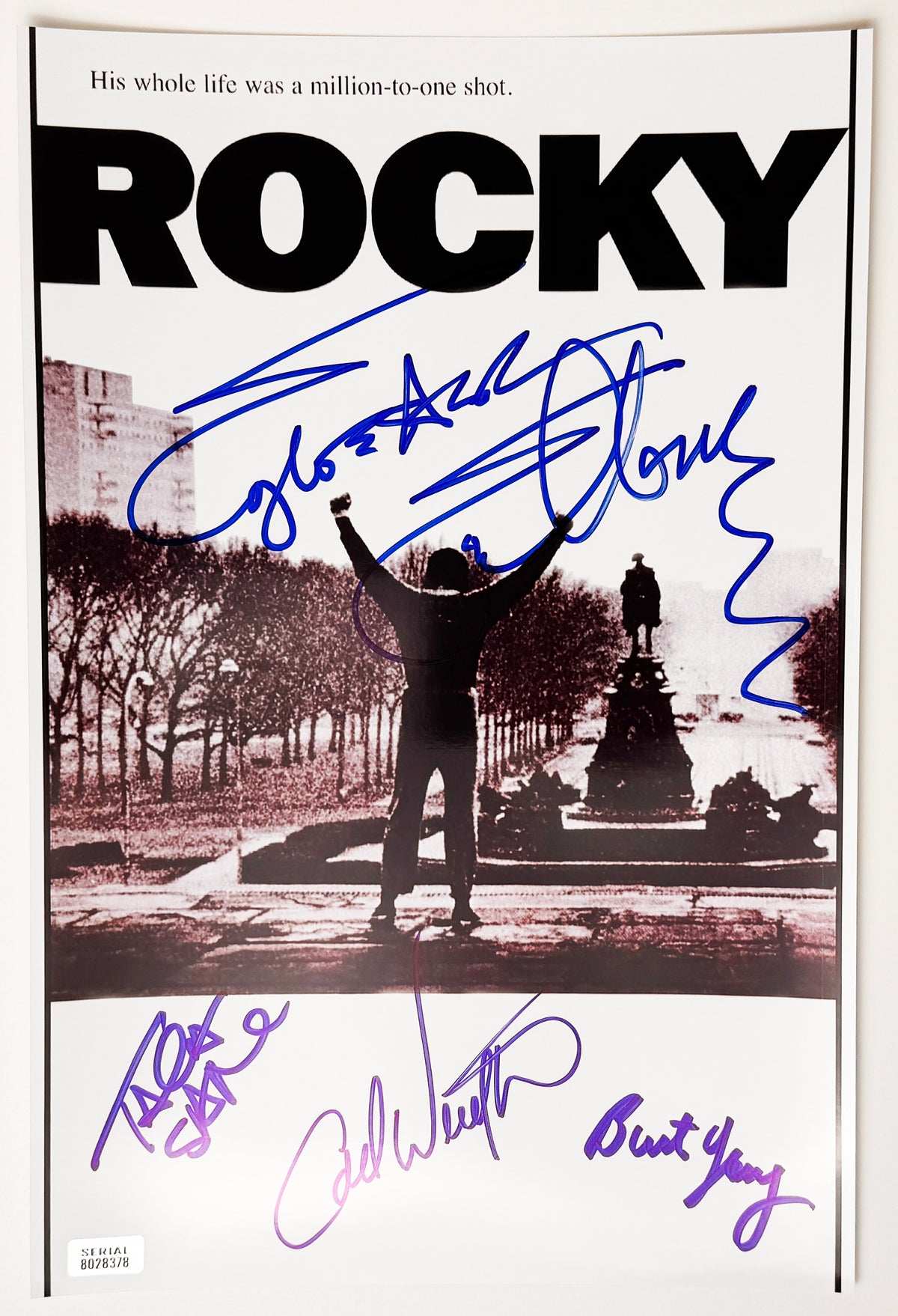 A cast autographed photo poster from the 1976 movie, ROCKY. Signed photo of Sylvester Stallone, Talia Shire, Carl Weathers, Burt Young in blue ink markers signatures. Photograph Sylvester Stallone autographs for sale on 8x12 inch photo.