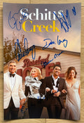 A cast autographed photo poster of the television series, Schitt's Creek also known as Schitts Creek. Signed photo of Eugene Levy, Catherine O'Hara, Dan Levy, Annie Murphy, Chris Elliot and Emily Hampshire in blue ink marker signatures. Photograph autographs for sale on 8x12 inch picture.