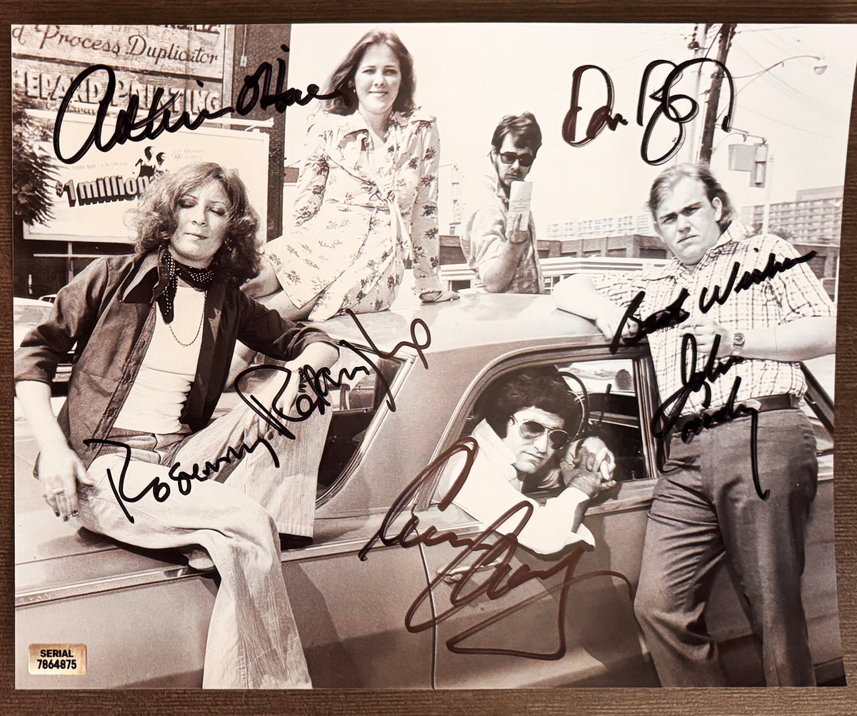 A cast autographed poster of the original SCTV actors. Signed photo of John Candy, Catherine O'Hara, Eugene Levy, Dan Aykroyd and Rosemary Radcliffe in black ink marker signatures. Photograph John Candy autographs for sale on 8x12 inch picture.