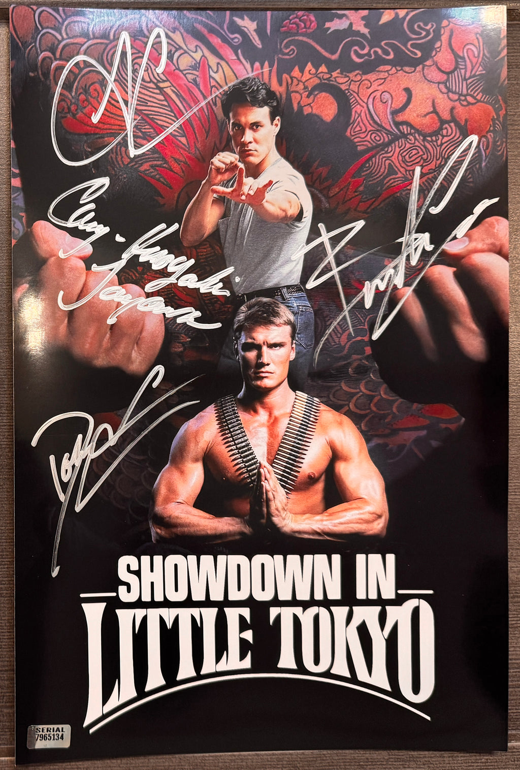 A cast autographed photo poster from the movie, Showdown in Little Tokyo. Signed photo of Brandon Lee, Dolph Lundgren, Cary-Hiroyuki Tagawa and Tia Carrere in silver ink marker signatures. Photograph autographs for sale on 8x12 inch picture.