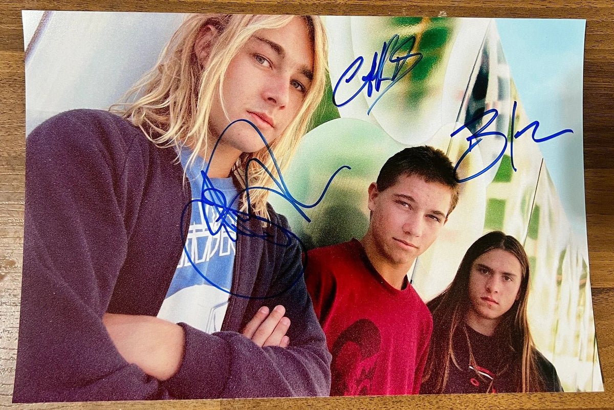 An autographed poster of the rock band, Silverchair. Signed photo of Daniel Johns, Ben Gillies and Chris Joannou in blue ink marker signatures. Photograph autographs for sale on 8x12 inch picture.