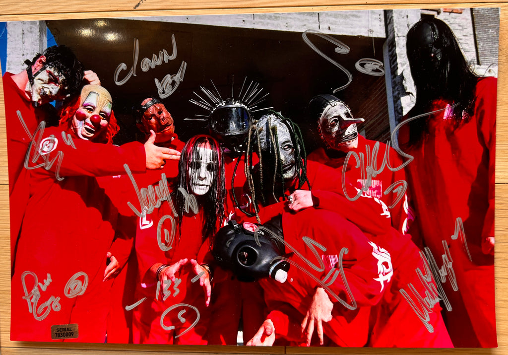 A full original lineup band autographed poster of the band, Slipknot. Signed photo of Corey Taylor, Paul Gray, Mick Thomson, Jim Root, Shawn Crahan, Craig Jones, Joey Jordison, Chris Fehn and Sid Wilson in silver ink marker signatures. Photograph autographs for sale on 8x12 inch picture.