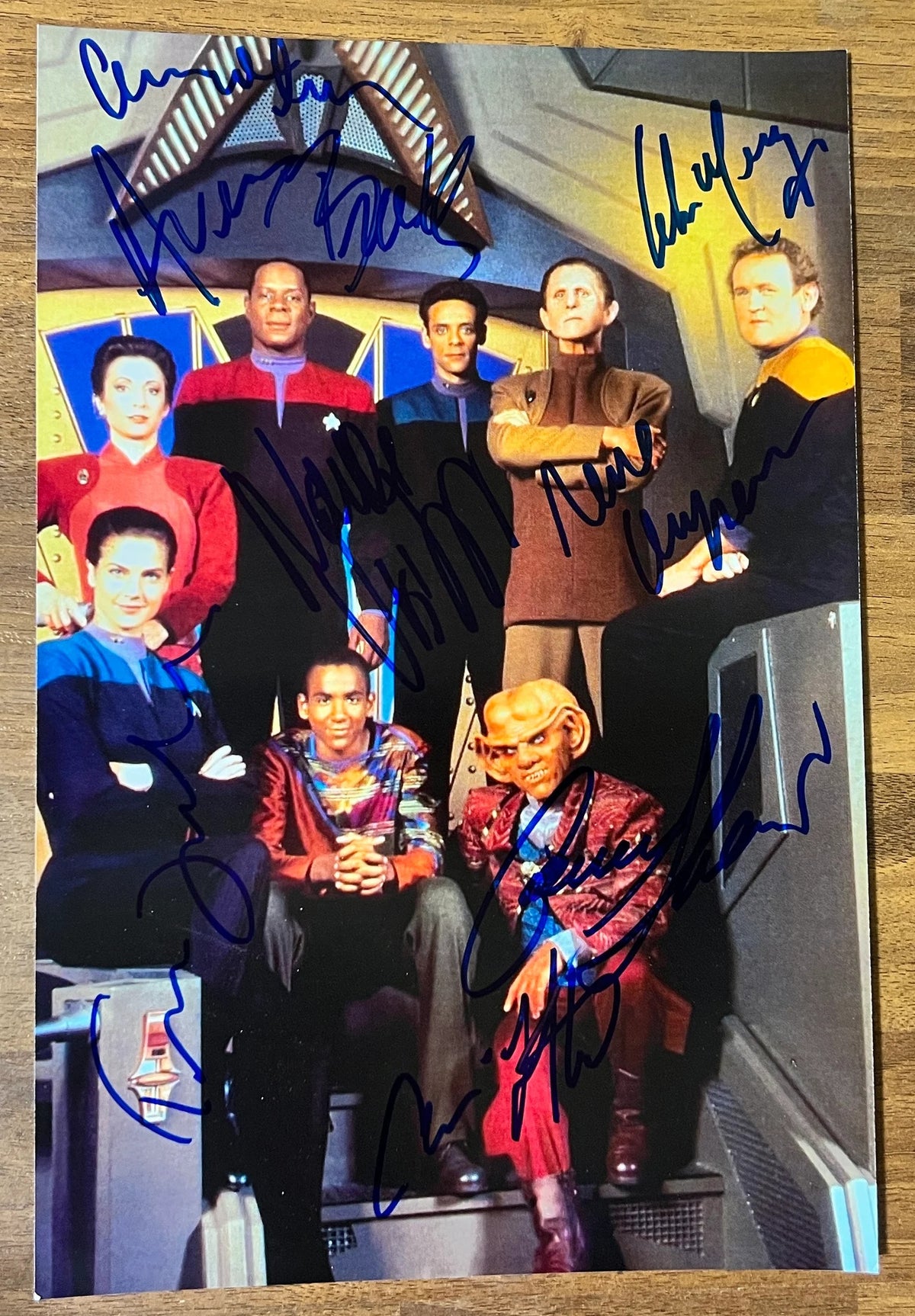 A cast autographed photo poster from the television series, Star Trek Deep Space Nine. Signed poster of Avery Brooks, Rene Auberjonois, Cirroc Lofton, Alexander Siddig, Colm Meaney, Nana Visitor, Armin Shimerman and Terry Farrell in blue ink markers signatures. Photograph Star Trek Deep Space Nine autographs for sale on 8x12 inch picture.
