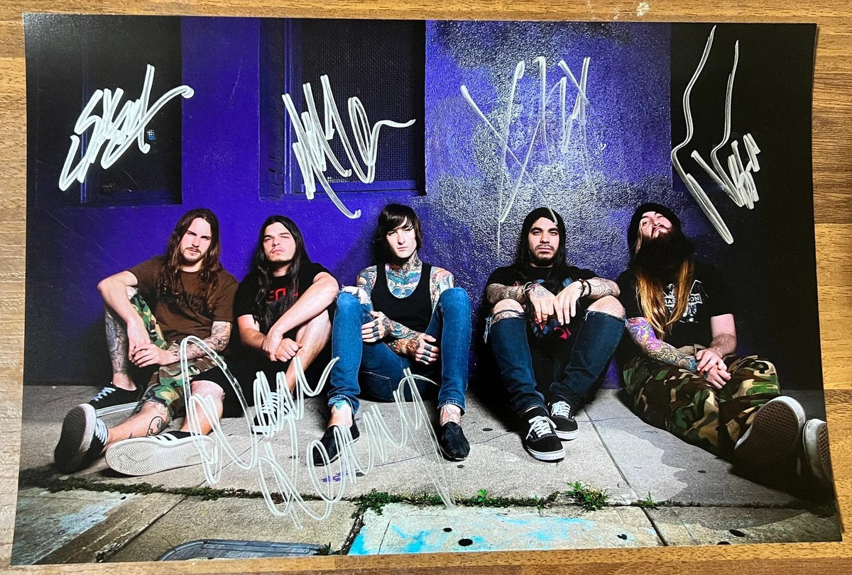 An autographed photo poster of the heavy metal band, Suicide Silence. Signed photo of Mitch Lucker, Mark Heylmun, Chris Garza, Dan Kenny and Alex Lopez in silver ink marker signatures. Photograph autographs for sale on 8x12 inch picture.