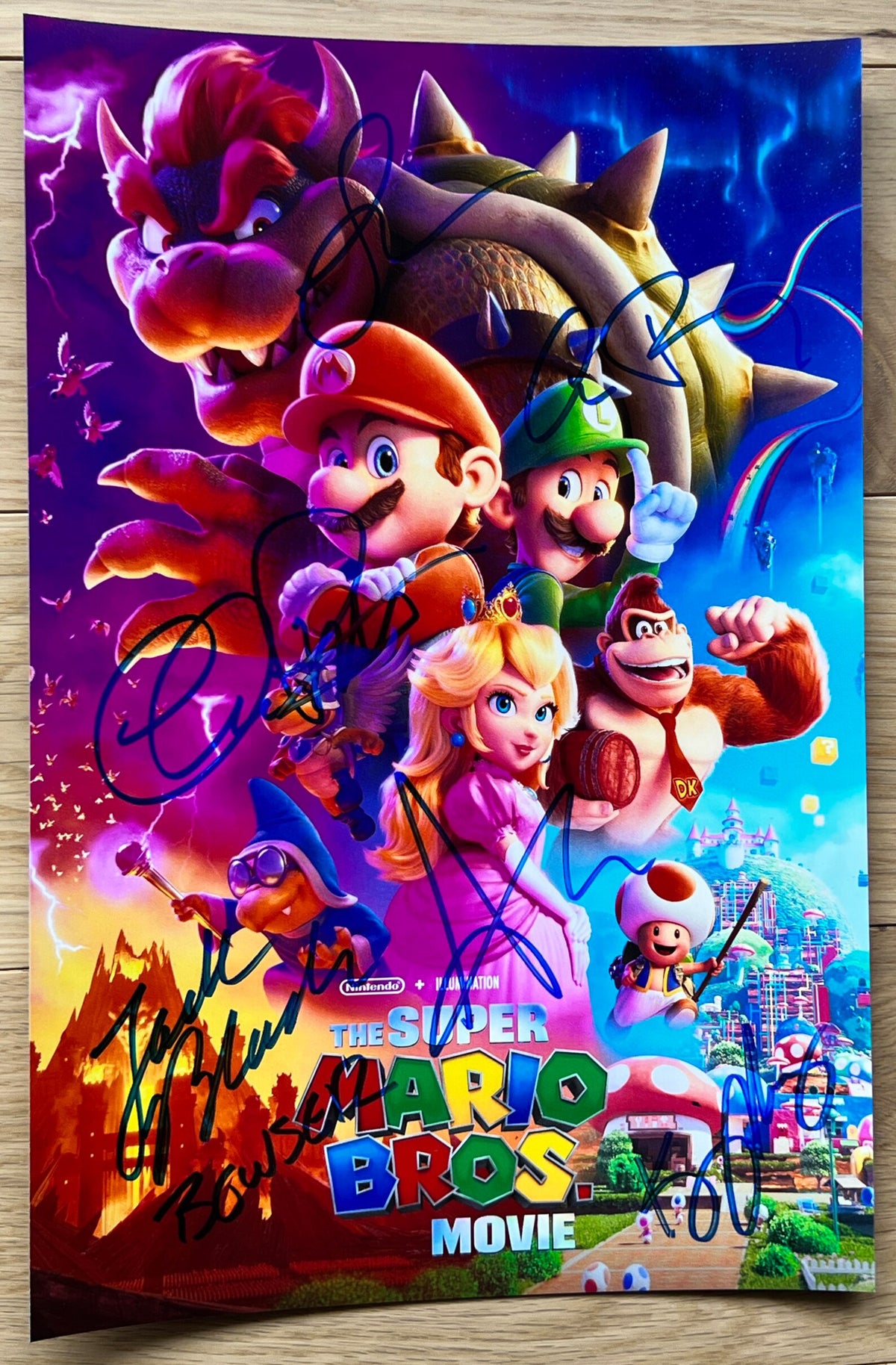 A cast autographed photo poster from the animated movie, The Super Mario Bros Movie. Signed photo of Chris Pratt, Anya Taylor-Joy, Charlie Day, Jack Black, Keegan-Michael Key and Seth Rogen in blue ink marker signatures. Photograph autographs for sale on picture.