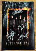 A cast autographed poster of the television series, Supernatural. Signed photo of Jared Padalecki, Jensen Ackles, Misha Collins and Mark Sheppard in silver ink marker signatures. Photograph autographs for sale on 8x12 inch picture.