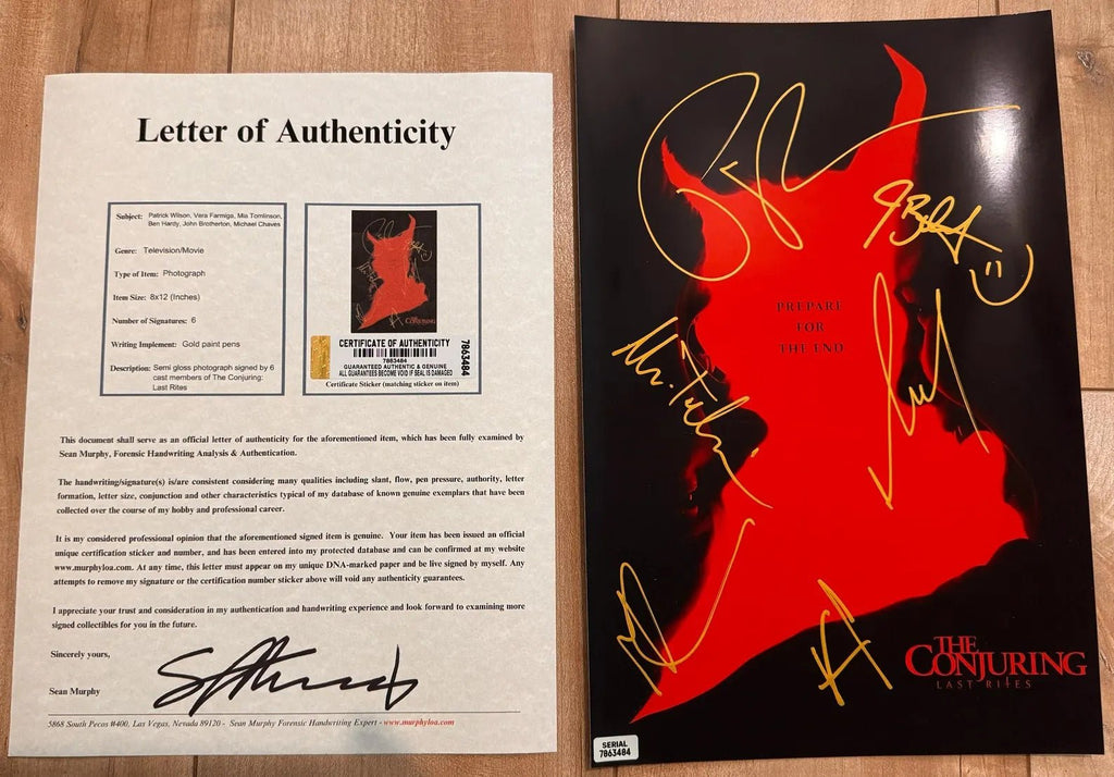A signed poster of the movie 'The Conjuring' featuring a bold red and black silhouette of the character Mother on a black background, autographed in gold ink by Patrick Wilson, Vera Farmiga, Mia Tomlinson, Ben Hardy, John Brotherton and Michael Chaves on an 8x12 inch photograph photo with COA.