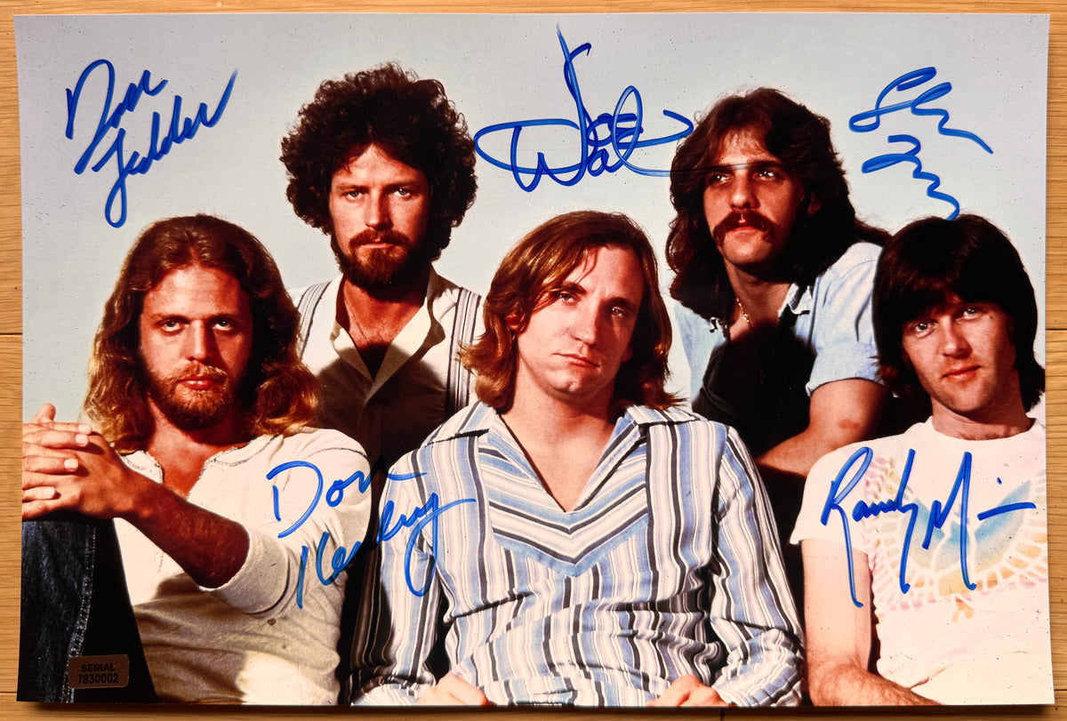 an autographed poster of the band The Eagles. signed photo of Don Henley, Glenn Frey, Joe Walsh, Don Felder and Randy Meisner in blue ink marker signatures. Photograph autographs for sale on an 8x12 inch picture.