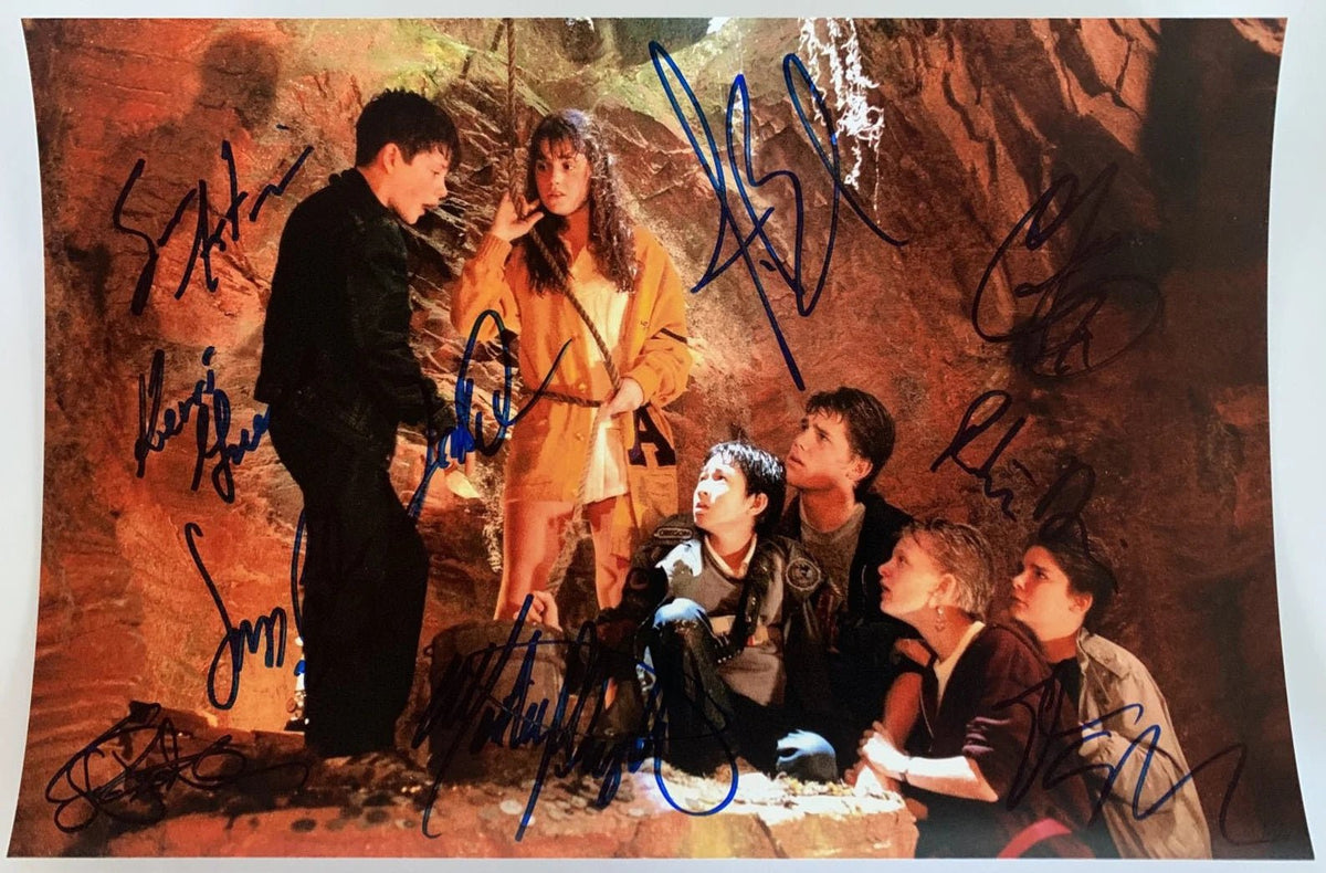 A cast autographed poster from the movie The Goonies. Signed photo of Sean Astin, Josh Brolin, Corey Feldman, Jeff Cohen, Kerri Green, Martha Plimpton, Jonathan Ke Quan, Robert Davi, Joe Pantoliano and Steven Spielberg in blue ink marker signatures.  Photograph autographs for sale on 8x12 inch picture.
