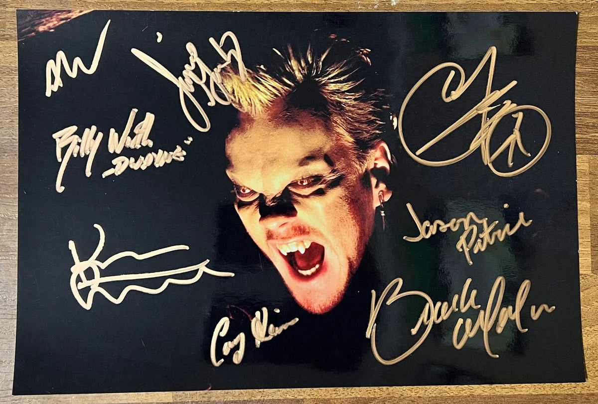 A cast autographed poster from the movie, The Lost Boys. Signed photo of Kiefer Sutherland, Corey Haim, Corey Feldman, Alex Winter, Brooke McArthur, Jami Gertz, Billy Wirth and Jason Patric in gold ink marker signatures. Photograph autographs for sale on 8x12 inch picture.